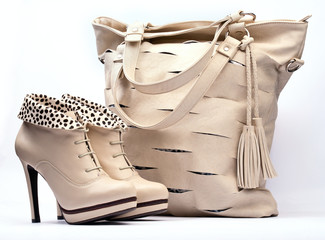 Creamy female boots and leather bag