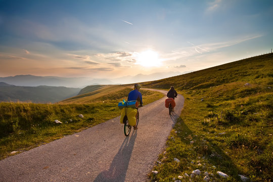Couple on bicycles on mountain road