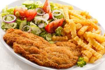 Pork chop, French fries and vegetables