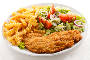 Pork chop, French fries and vegetables