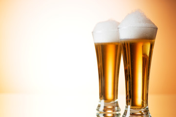 Beer glasses against the colorful gradient background
