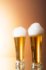 Beer glasses against the colorful gradient background