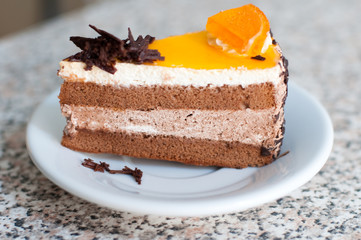 chocolate cake with piece of orange on top