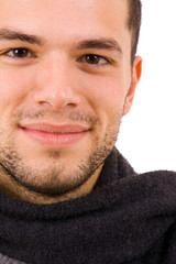 Happy young man dressed with winter clothes, isolated on white