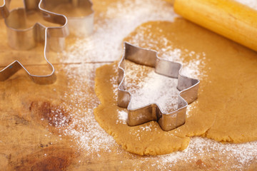 christmas gingerbread tree cookie cutter on dough with rolling p