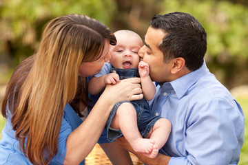 Fototapeta premium Happy Mixed Race Parents Playing with Their Son