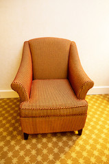 Interior of the room - modern arm chair against the wall