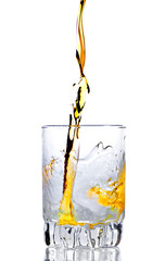 Whisky,rum or any other golden liquor being poured into a glass