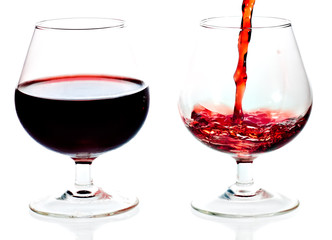 Red wine being served in transparent glasses