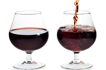 Red wine being served in transparent glasses
