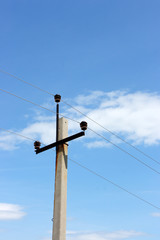 Fototapeta premium High-voltage pole against a blue sky