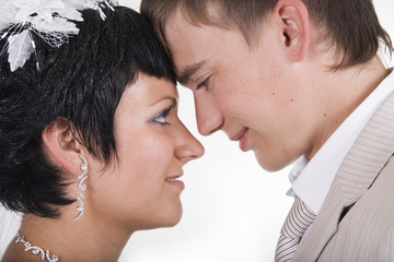 Loving groom and beautiful bride are happy together.