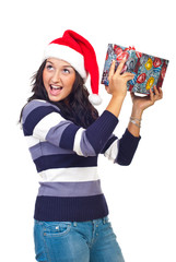 Girl lifting a gift and listen to what's inside