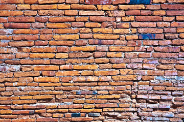 wall of red old bricks in a temple area,