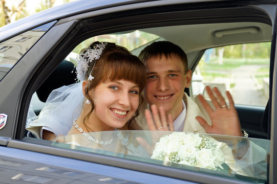 the couple in a wedding car
