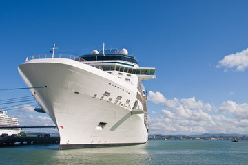 Huge White Cruise Ship Tied to Pier with Blue Rope