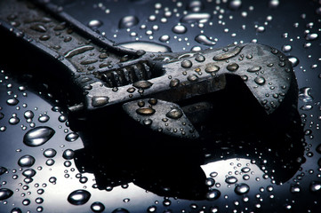 Adjustable spanner , water drops background , wrench