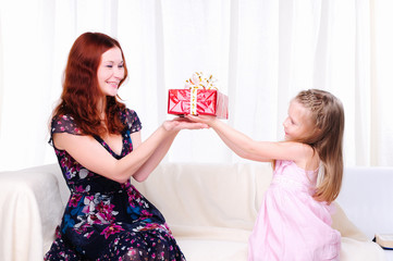 Little girl mom gives a holiday gift