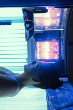 Tanning solarium young woman laying