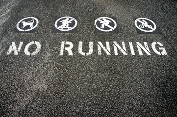no running sign painted on the ground
