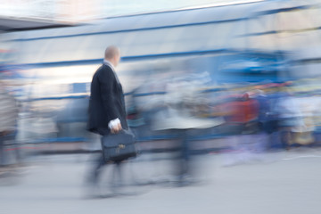 Blurred image of businessman rushing to office in the morning