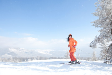 Happy girl with ski in the winter landscape