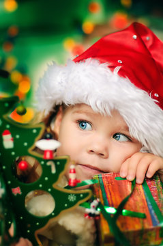Happy small girl in santa hat have a christmas
