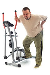 Fototapeta na wymiar Man with back ache near a training device