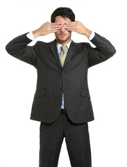 Businessman closing his eyes his hands.