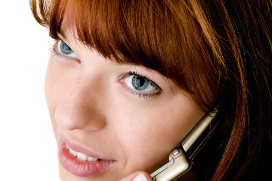 Beautiful red haired girl speking on cell phone face close-up