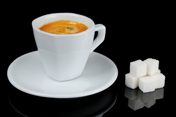 The cup of espresso coffee with sugar on black background