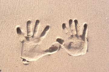 Hand prints on sand