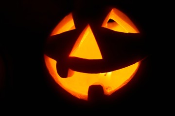 Creepy carved pumpkin face, with a smile