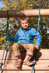 Obraz premium kleiner Junge auf Klettergerüst