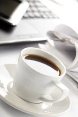 Cup of fragrant coffee on a morning paper business news