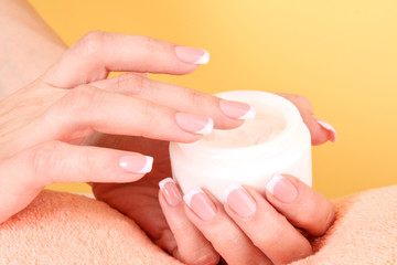 Woman applying cream on her hand