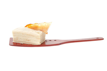 cream cake on wooden spatula