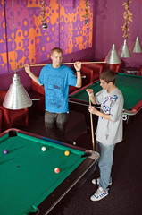 Concentrated young men playing snooker