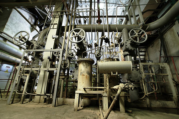 Equipment, cables and piping as found inside of a modern industr