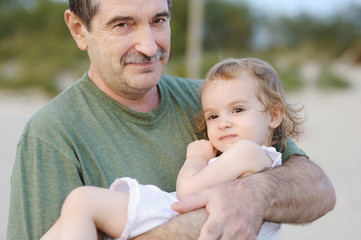 Grandfather holding his granddaughter