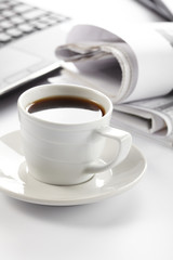 Cup of fragrant coffee on a morning paper business news