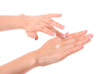 Closeup of beautiful female hands applying hand cream isolated o