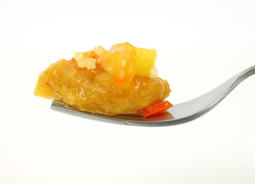 Fork filled with sweet and sour chicken