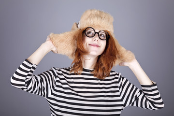 Funny girl in winter cap and glasses.