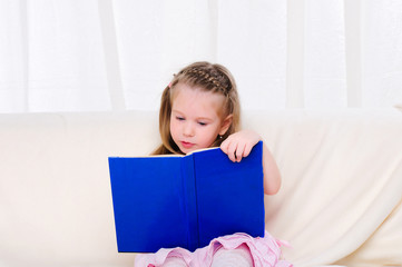 Little girl lying on the couch