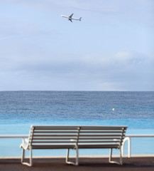 Promenade des Anglais in Nice, France (bench and an airplane)