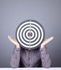 Boy with dartboard in place of head.