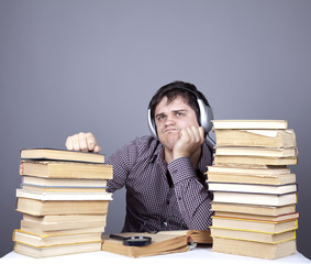 The young student with the books and headphone isolated.