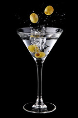 Martini cocktail with olives and splash