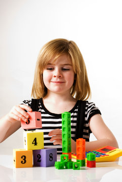 child stacking blocks